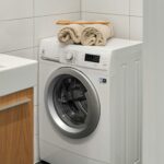 Lave-linge blanc dans un espace buanderie propre